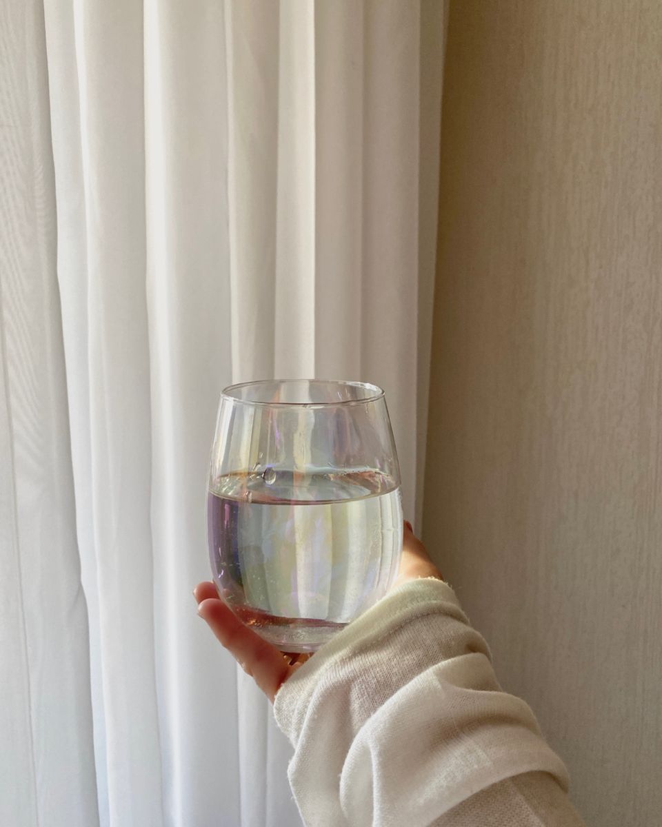 Clear glass of water on a bright table representing mindful hydration